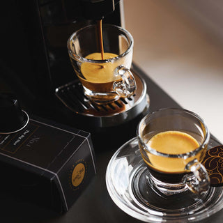 The Big Shot Nespresso compatible coffee pods with coffee pouring from a pod machine